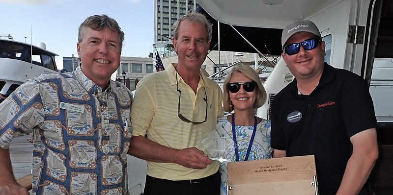 Picture of Jeff, Ryan, Mike and Patsy on boat being given award for Nordhavn 47