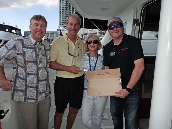 Picture of Jeff, Ryan, Mike and Patsy on boat being given award for Nordhavn 47